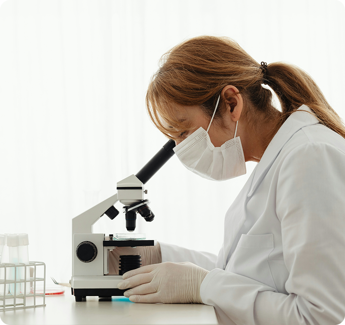 Researcher working with a microscope